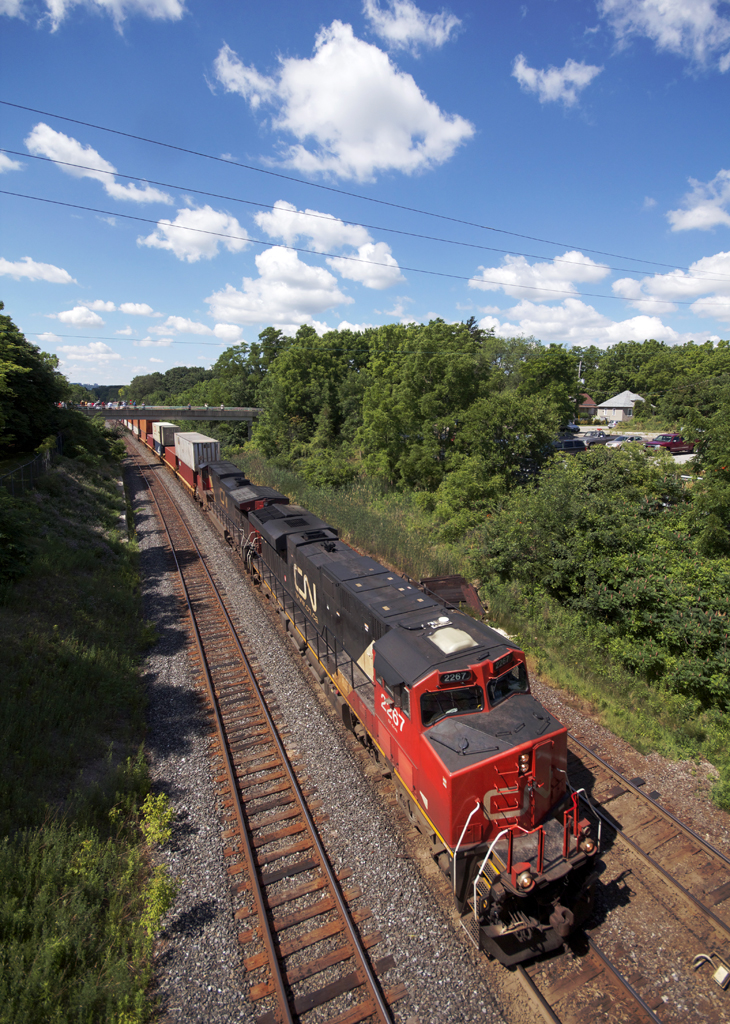 CN priority intermodal 148 swoops around the corner off the Dundas Sub, rushing into Burlington on the Oakville Sub, before taking the grade up Milton area on the Halton Sub for BIT.