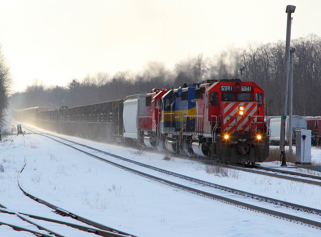 CP 242 with a trio of EMDS, arrives into Guelph Jct to complete it's work. Currently on the headend is a load of continuous welded rail.