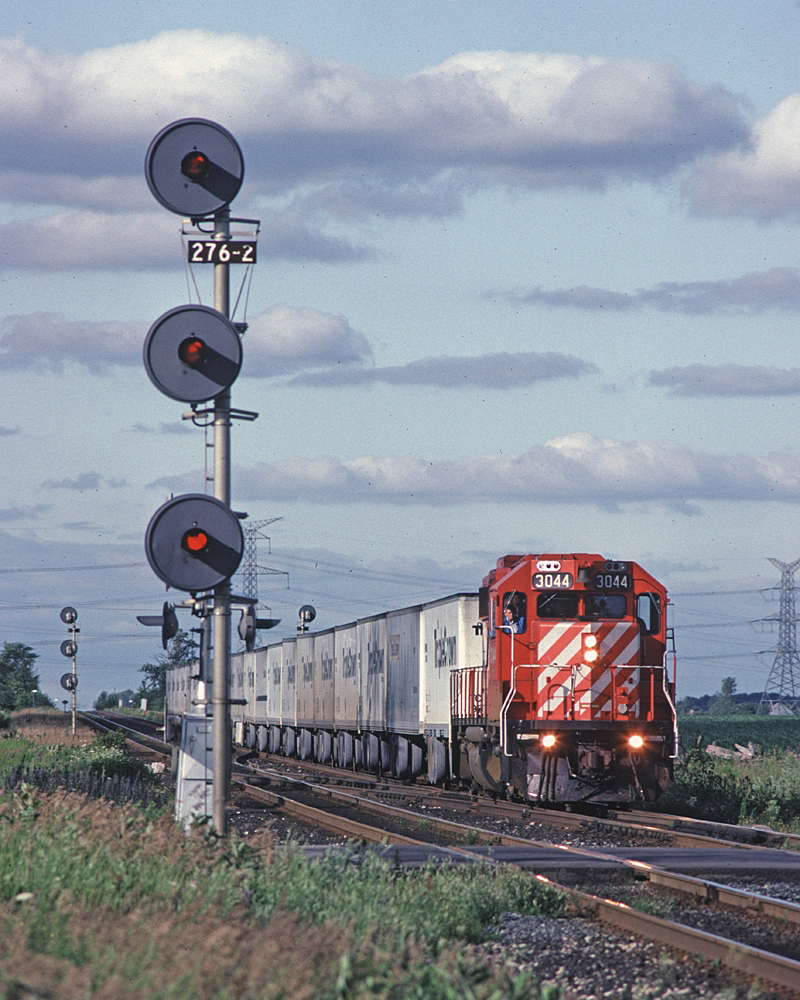 CP Rail GP38-2 3044 leads the #529 (Toronto - Detroit Roadrailer) through Hornby. #529 left Lambton around 1800 and went west with priority over pretty much everything.