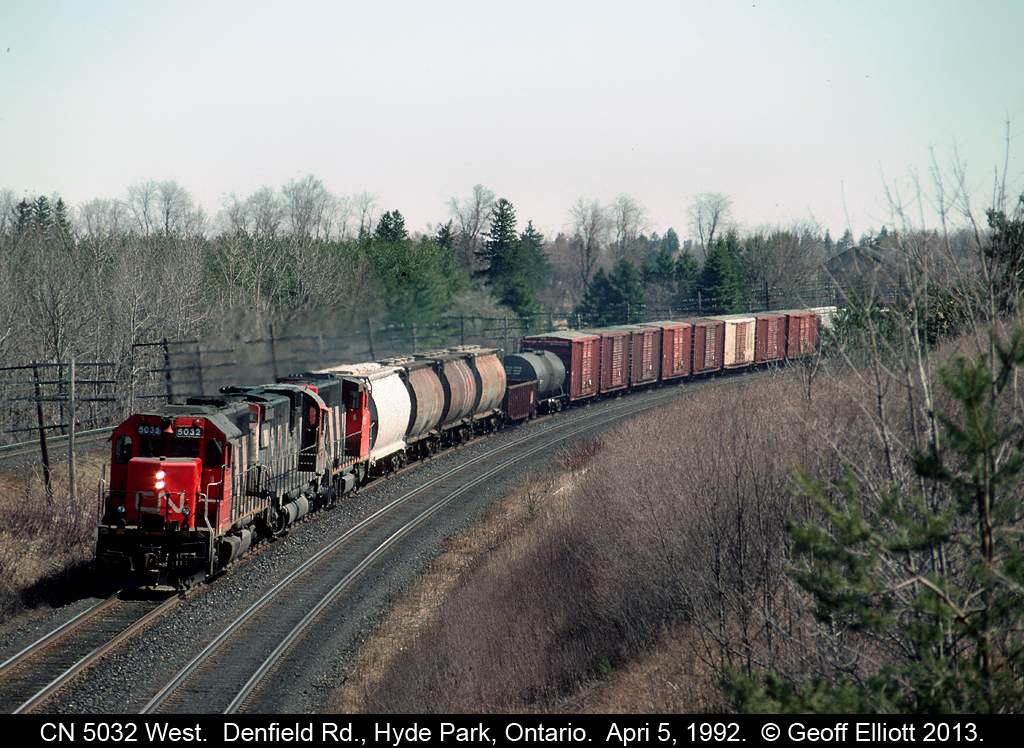 CN 5032 leads a westbound around the bend @ Denfield Road just west of London, Ontario back in April of 1992.