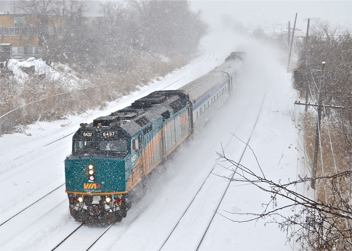 Two trains for the price of one! There is so much snow in this photo it's hard to tell, but this is two VIA trains combined into one. Until Hervey Junction in northern Quebec, VIA 601 to Jonquière and VIA 603 to Senneterre run as a combined train. Each train has an F40, a stainless steel coach and a stainless steel baggage car. VIA 6437 is at the head end and barely visible two cars back is VIA 6446.