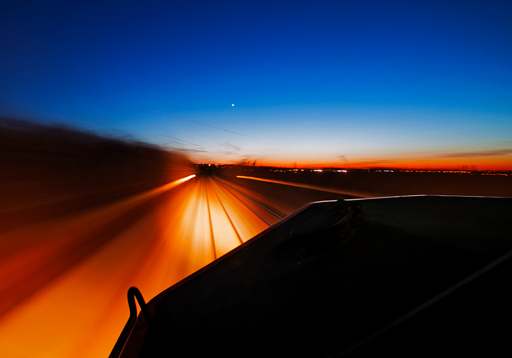 The railway life, all but just a blur into the sunset, one mile at a time.