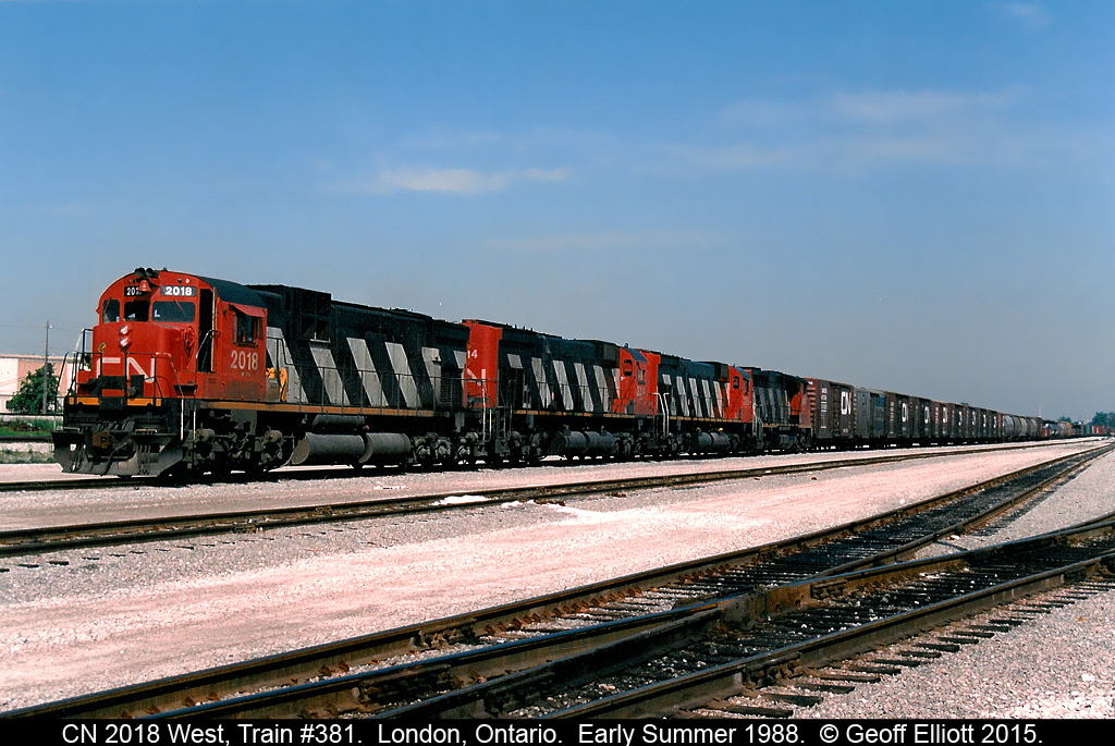 It's early summer of 1988 and CN train #380 sits in London Yard waiting to depart for Windsor.  C630M #2018 is at the helm with 2 M636's and a GP40-2W rounding out the quartet today.  On the head end of the train is a number of CN Insulated boxcars for Heinz in Leamington, including 1 "SuperTherm" car.  These cars will be setoff in Comber as 380 runs across the former NYC/PC/CR CASO subdivision from Fargo to Windsor.  Gone now are the Alcos, the CASO subdivision, and even Heinz no longer exists in Leamington......  :-(