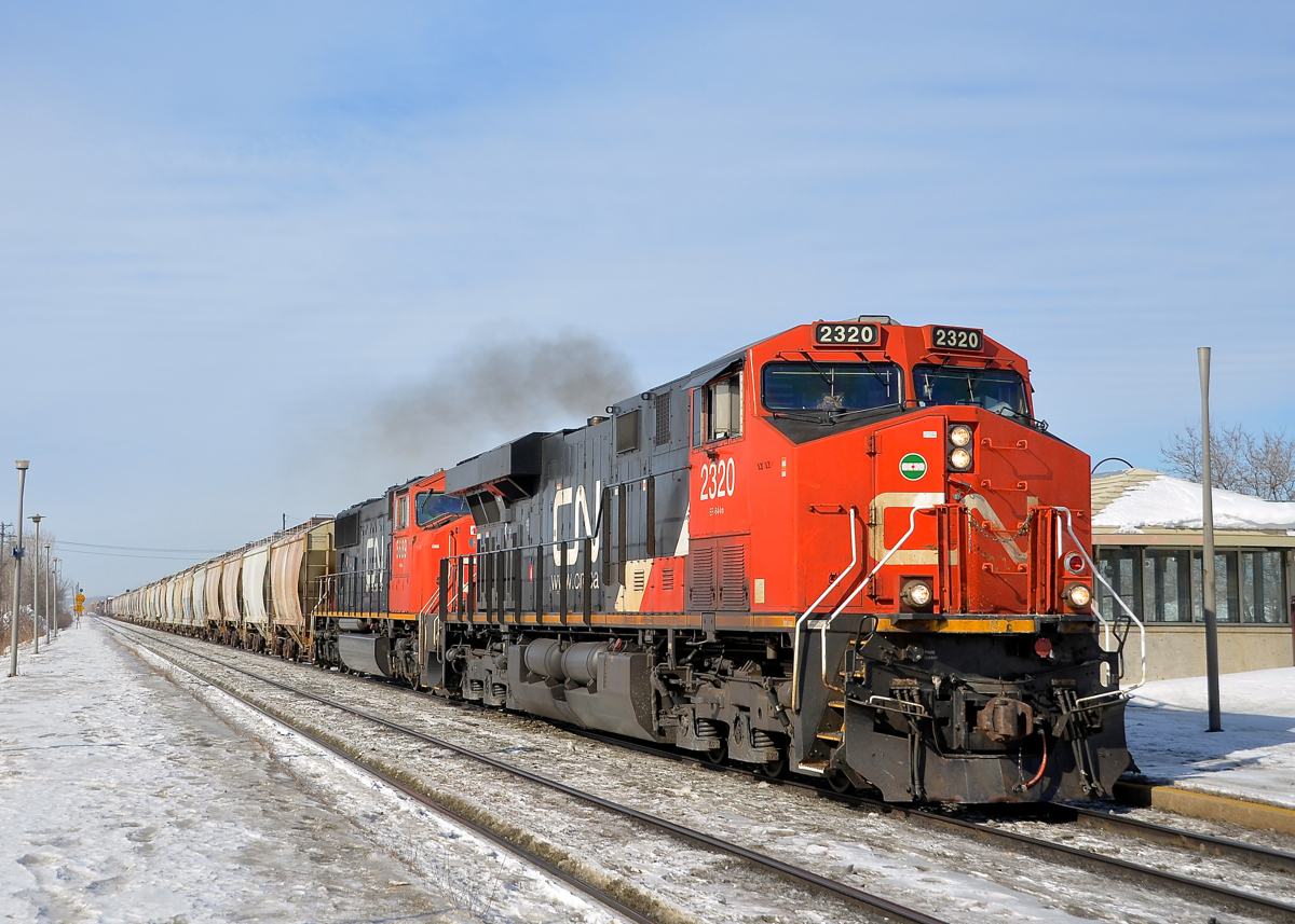 A later than usual CN 372 passes through Dorval with CN 2320 and CN 5689 at the head end and CN 8935 as the DPU during a brief sunny spell.