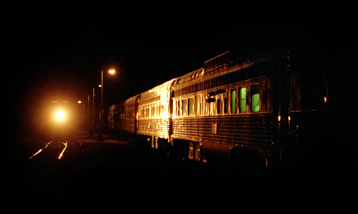 With the westbound Ocean stopped at Matapédia station, the headlight of the Chaleur reflects off the stainless steel coaches as it arrives from Gaspé. The trains are combined here for the trip onwards to Montreal.