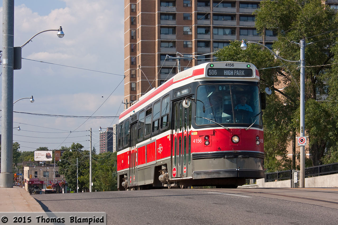 A route 506 streetcar climbs the bridge over the Danforth GO station.