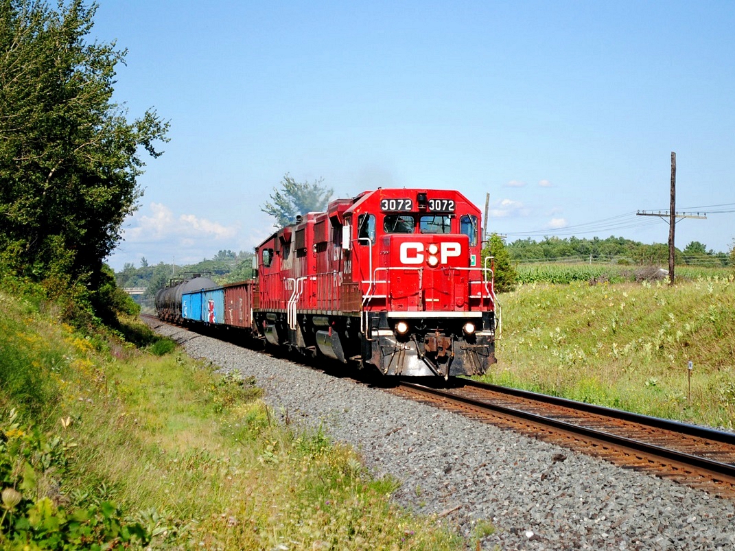 What a catch! Got a new Nikon wanting to try it out. I have been waiting patiently for this to happen. With no scanner doing it traditional way of sitting all day and waiting, I finally got a pair of GMD GP38-2's on a small train heading west. Perfect lighting on a hot summer day. I couldn't be happier. It's really almost a rare sight as GE's and ECO's are on these rails.