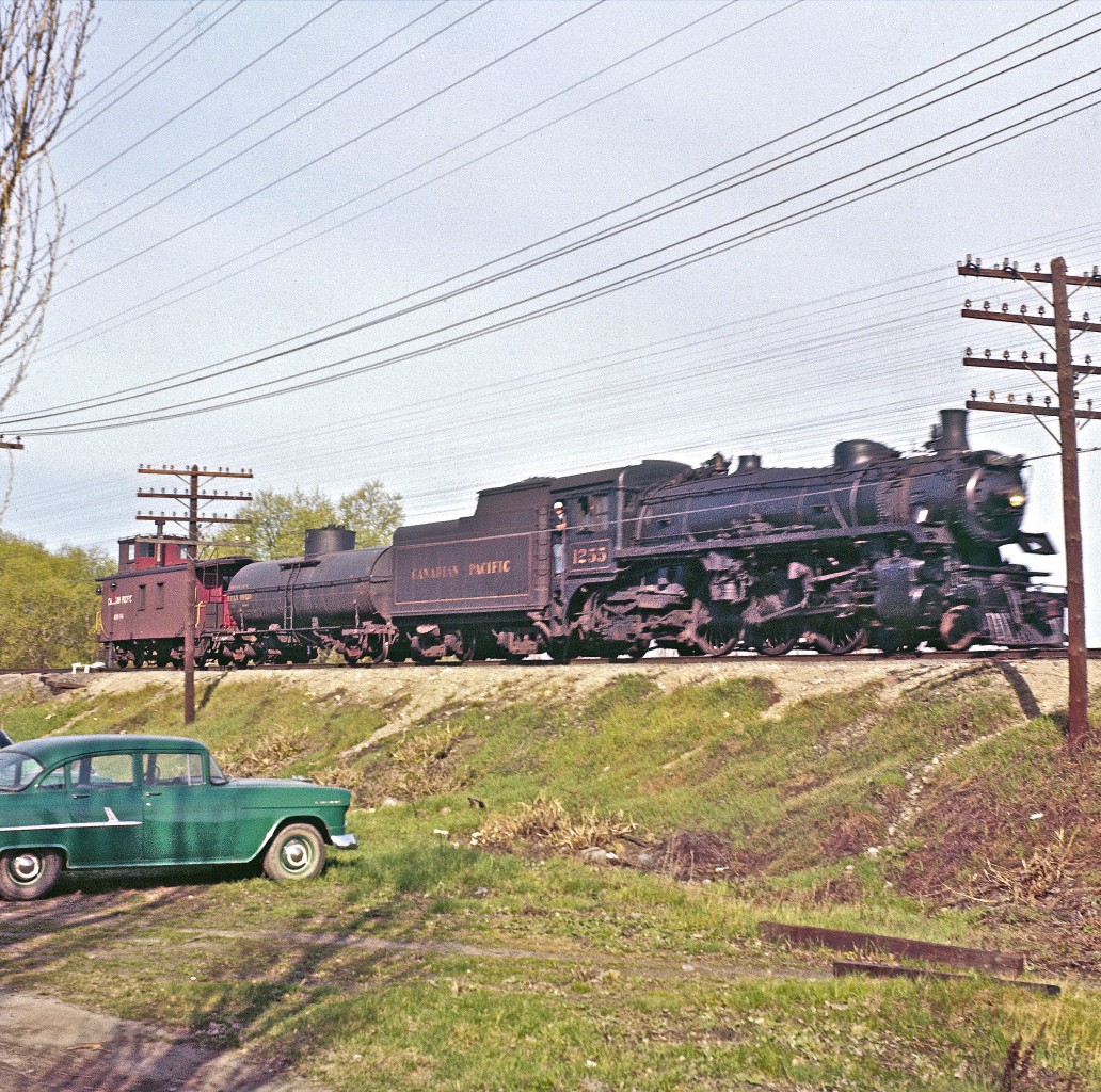 A few things strike me as interesting in this image...


The automobile is a 1955 Chevrolet Model 150 (six cylinder)...


There was no shortage of power lines back in 1958...


Del's state-of-the-art Nikon camera was no match for a speeding Pacific-type locomotive.  I'm guessing that he was frustrated by his inability to split a second into a thousand tiny pieces.