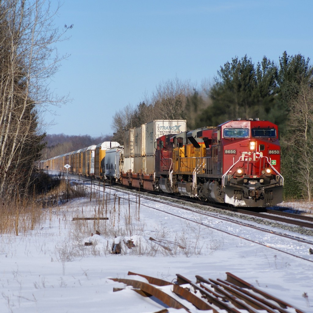 CP 8650 is seen blasting trough Essa (Mile 59) with UP 3736 and CP 9633 trailing. On this day, CP 420 will arrive at Spence, set off 49 cars, and continue south with a very short, and maybe just slightly over powered 10 car consist. Its been a real treat seeing foreign power on the CP lately, bringing some nice contrast to an otherwise very red landscape.