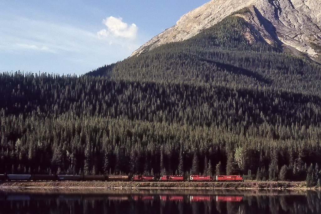 Just over the continental divide, 4 sd40-2 variants are about to descend the Big Hill at Wapta Lake.