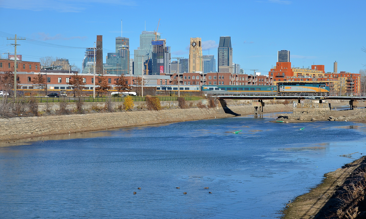 Downtown Montreal in the background. VIA 632 is crossing the Lachine canal, with the skyline of downtown Montreal in the background.