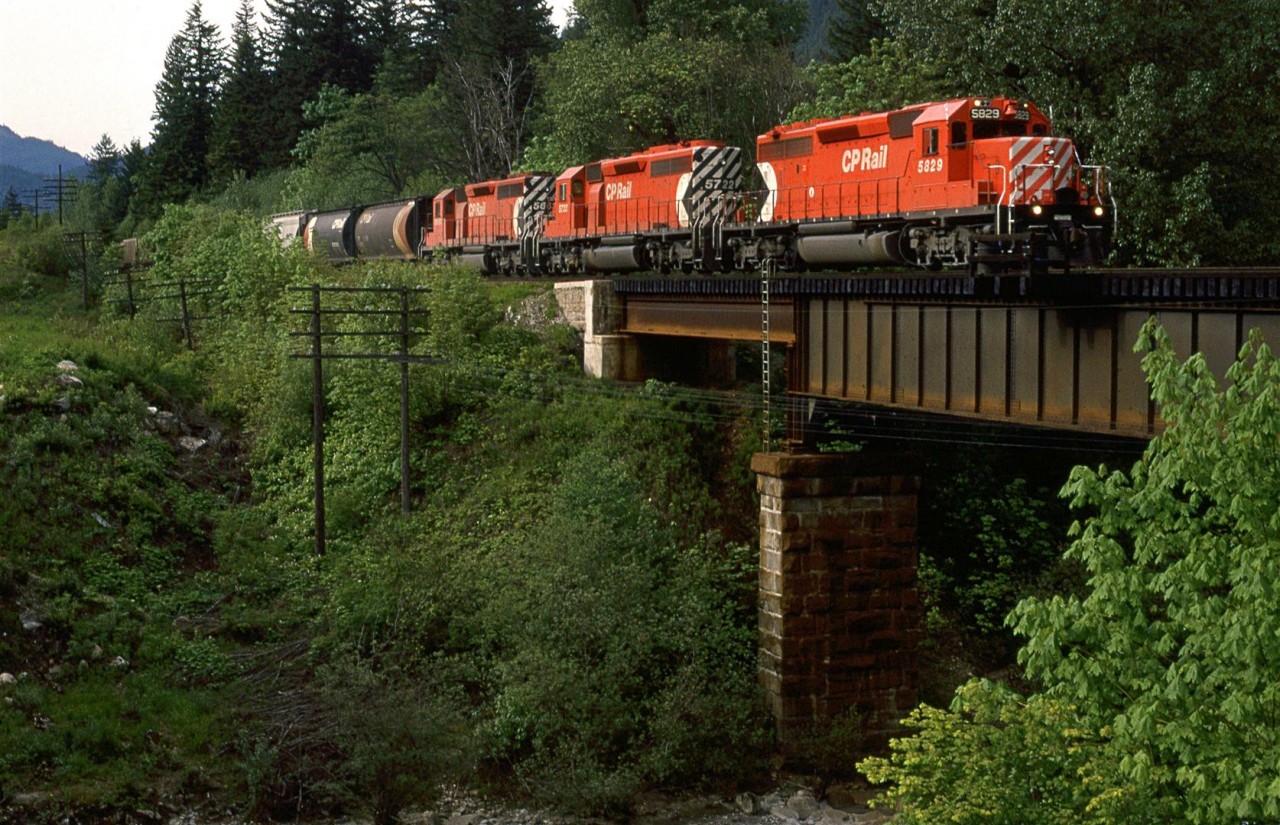 A westbound potash train crosses Emery Creek just outside the Provincial Park with the same name. CP was running a mixture of cars to haul the potash, not the solid sets of Canpotex round hoppers that would be seen on CN.