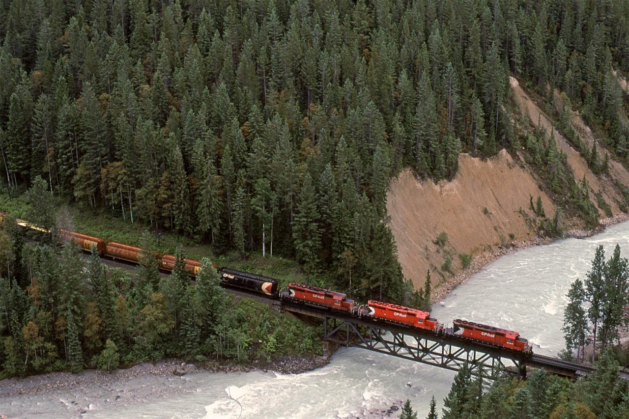 A westbound manifest crosses the Kicking Horse River in the canyon bearing the same name. There will be 4 more river crossings before Golden.