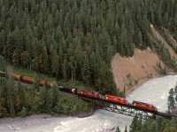 A westbound manifest crosses the Kicking Horse River in the canyon bearing the same name. There will be 4 more river crossings before Golden.