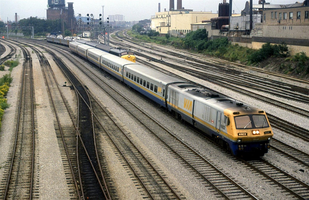 The LRC train is likely a revenue move, however the train that is somewhat blocked it more likely a transfer from Mimico, what with 2 engines, two passenger cars and four RDC's.
It was a very heavily overcast morning in Toronto. Shortly thereafter the rain would start.