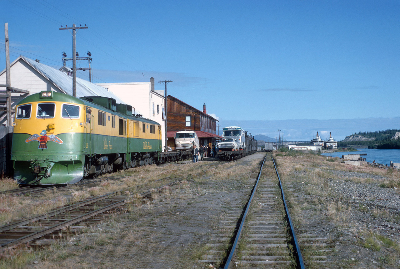 This is my personal favorite shot and image of preparing the Southbound train to Skagway, Alaska. Automobiles, Bus and Camper were loaded directly in front of the Whitehorse Station to flat cars. A switching progress was required to bring the loaded cars to the Southbound train. I wished that this image was still possible, today. But all is history. A part of the history can be found at my web page http://www.whitepassfan.net.