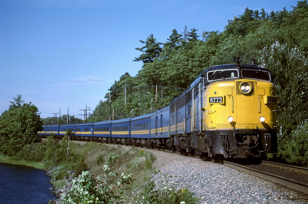 This is my wife's shot. I was standing nearby to take my own photo, but I forgot to cock the shutter release (wasn't my first time nor the last with a manual advance camera). This is a rather nice location along Shubenacadie Grand Lake near Laurie Provincial Park.
Incidentally, the train is eastbound, nearing the end of its journey from Montreal.