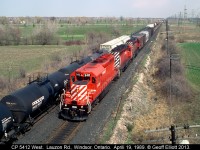 CP 5412 West rolls through Begin-End CTC sign Walkerville as an eastbound CP freight waits patiently to depart Walkerville siding and head for London on April 19, 1989.