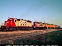 All about 'pairs'.... A pair of SOO SD40-2's, 6611 and 6622, lead a brand new pair of Union Pacific SD60M's past Windsor South depot in Windsor, Ontario in late afternoon sun back on April 19, 1989.