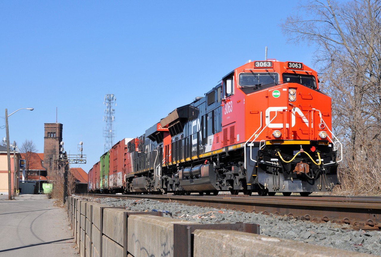 Brand new CN ET44AC 3063, along with CN 2853 lead 394 with 146 cars through Brantford on a sunny April morning