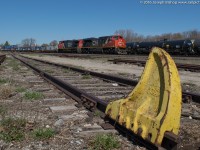 CN 148 rolls through Brantford behind CN 8809 and BCOL 4647 on a sunny April morning.