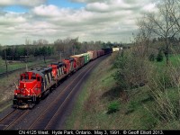 CN GP9r #4125 leads 2 sisters on a westbound freight as it rolls through the curve approaching the Denfield Road bridge.  Back in 1991 there was plenty of room to shoot, but now in 2016, things are very overgrown and shots like this are almost impossible.