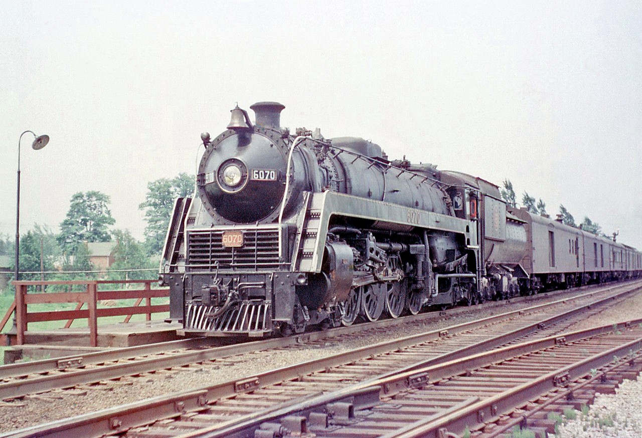 Bill Thomson Photo: Canadian National 4-8-2 6070 (one of  CN's famed U1f class “Bullet Nose Bettys”) stops at Port Credit Station  with a passenger train in 1956.