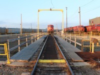 Line 'er up boys. CP 8801 is ready to go for a ride on the turntable. Stored GE AC4400's watch gloomily on the right.