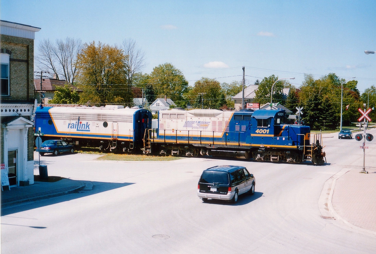 I didn't have a whole lot of luck with trains running the Exeter sub. So I enjoyed the 'chase' when I could. On this particular day I followed GEXR 3835, RLK 1401 and 4001 into Hensall. When they uncoupled from the train to pick up some cars of plastic tubing, I saw my chance to get a decent shot of 4001, which I wanted because it was still lettered for Lakeland & Waterways, and only had been in the east about 6 months. Split second decision to scurry up someone's fire escape on the main drag to get this overview. Disappointed I could not squeeze in the cab unit, but I accepted  the balance I got. When in doubt, climb something !!