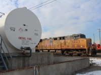 Union Pacific pooled power ES44AC #5542 backs onto the locomotive servicing island with the storage tank labeling showing it's preferred type of fuel.