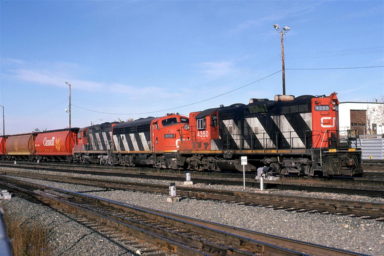 I believe that this is the train coming in from the Westlock Sub. It might have been #418 - at least that is what it was several years later. It may also simply have been a grain train from the Westlock Sub - the giveaway is the lightweight power. 
It is one of the very few shorts that I have of F units in freight service. 
On this occasion, there was another railfan beside me recording the scene on video. I commented that the lighting sucked before I realized that he was recording. Encounters with other railfans were very rare for me, and I was not up on the etiquette. So, if that guy ever reads this, I apologize again. 
The going away shot has better light.