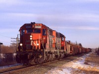 It is getting late in the short day - possibly the shortest day of the year, and a westbound welded rail train is approaching Wildwood. With the thin clouds and the low sun angle, you would get this greenish light up that way in the winter.