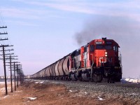 An eastbound empty potash train leaves Edmonton for the Saskatchewan potash mines. On the right can be seen part of the Domtar creosote operations. The pole line remained in place for a number of years to come.