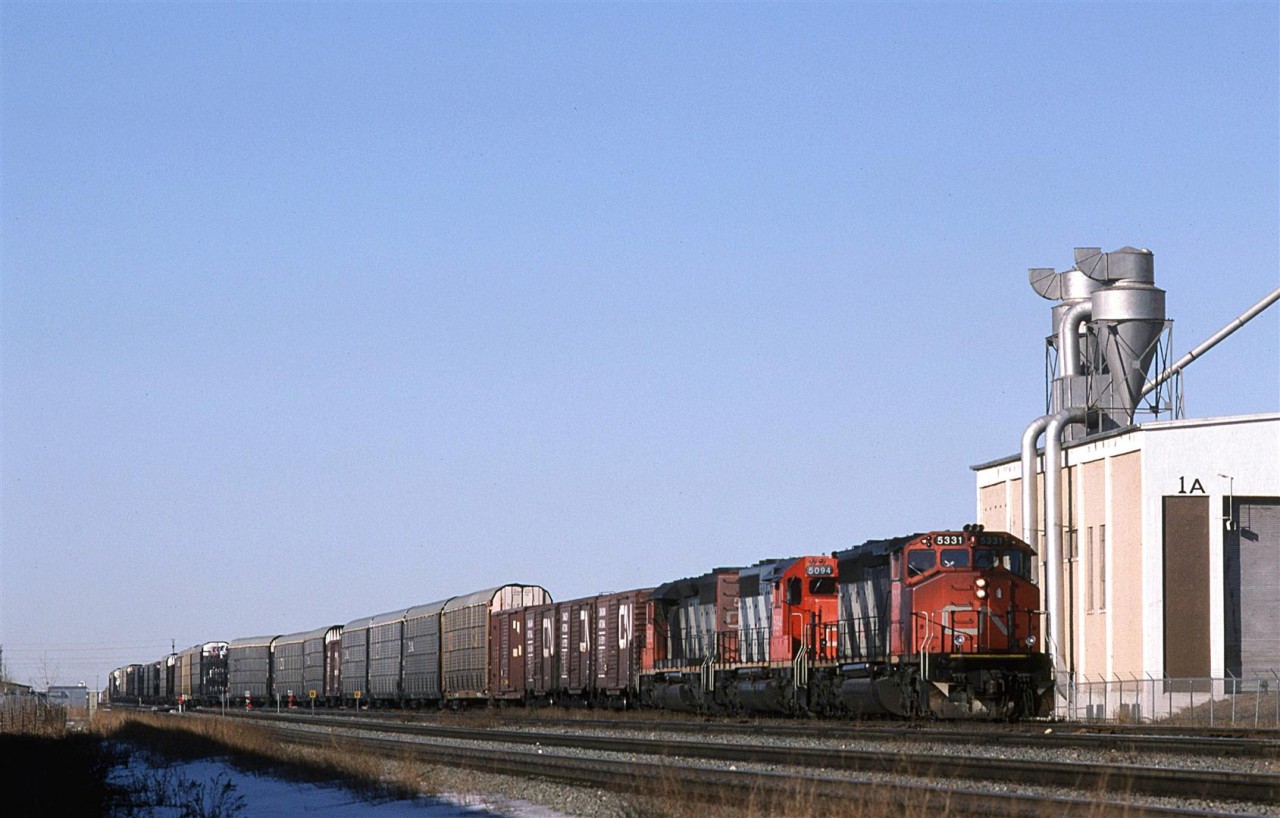 An eastbound auto train is approaching Calder shops and yard at 1033hrs. Part of the large Alberta Terminals' grain handling facility as seen at right. Dunvegan Junction is just to the left of AT's property, and is where the Westlock Sub to NW Alberta and Northern BC splits from the mainline Edson Sub.
We must have been having some good weather, and I was able to take a break from my studies on this mid February day.