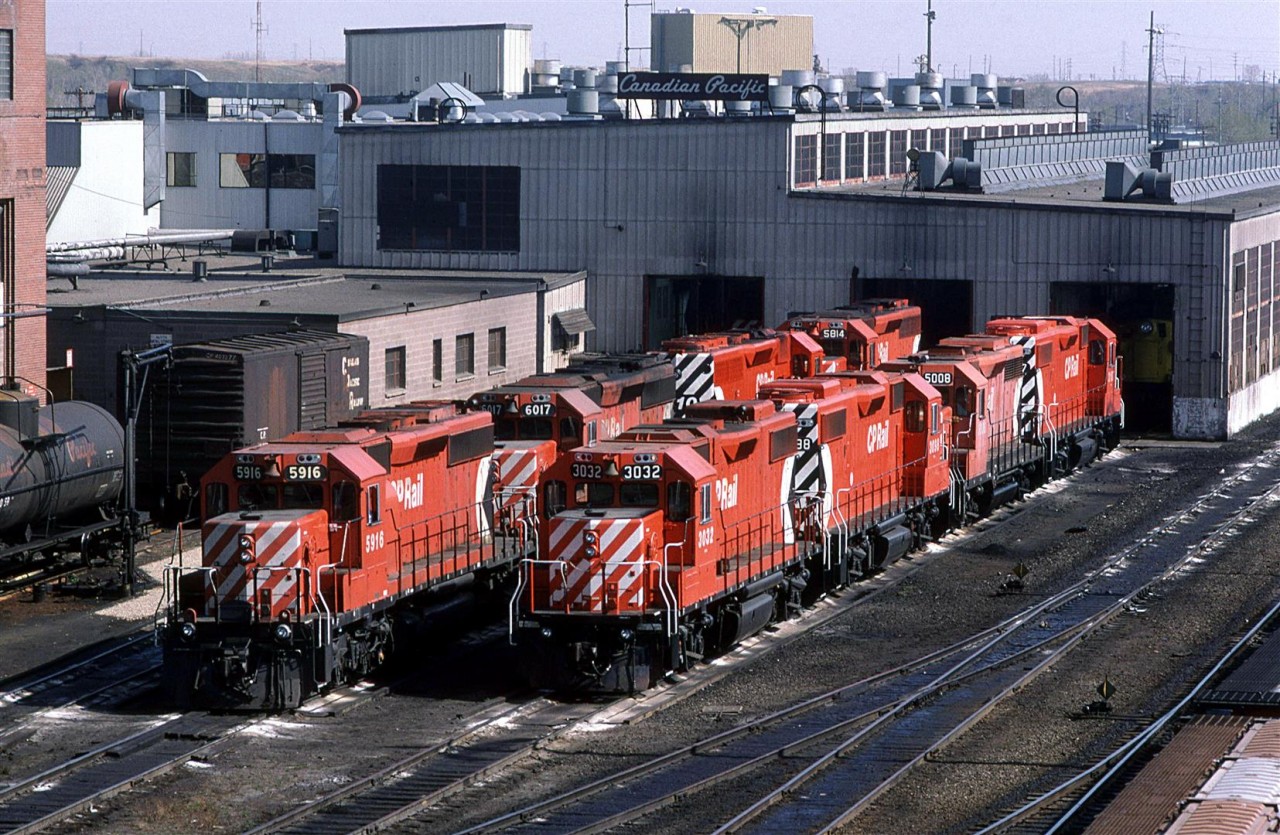 A typical mid-'80's view of the CP shops at Alyth - SD-40's and GP-38's. The four-axle set is likely the Exshaw Turn's power.
Note the "Canadian Pacific" sign on top of the building. I think that might have been a recent (at the time) addition (Or, maybe, I did not notice it there before - a very likely scenario).