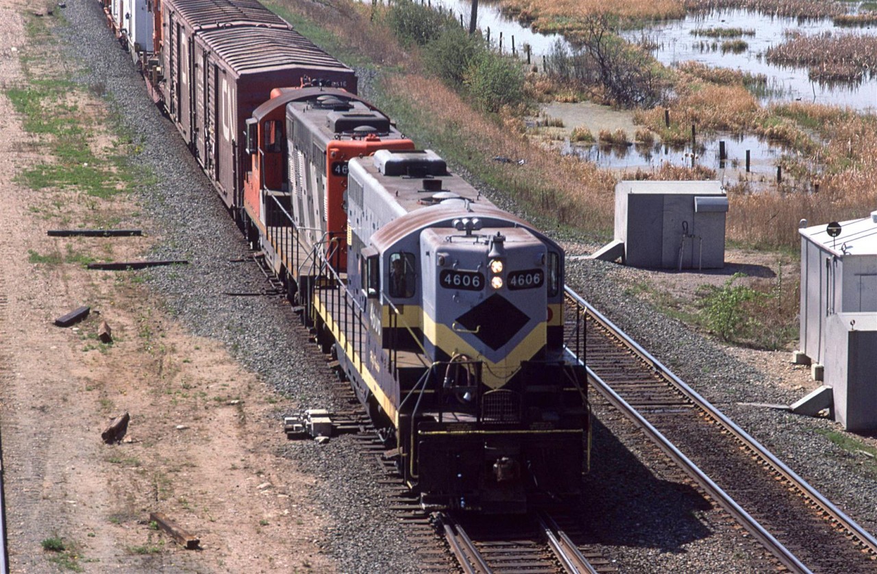 I arrived in Edmonton as things were becoming relatively boring. The NAR was absorbed into CN and the downtown rail facilities were being rationalized. (by coincidence, I would leave Edmonton as things were becoming more interesting by having CN spin off a number of their branch line operations.)
Here, we have an eastbound Work Extra returning to town, led by an ex NAR GP-9. I don't think CN was really quick to repaint the NAR units but they were still rare to see, but at least twice I saw them of the wrecker train.