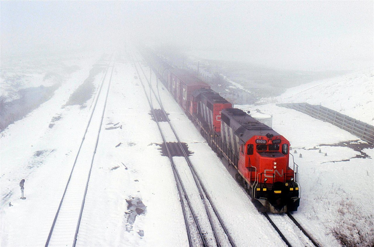 This is one of the things that I do not miss about Alberta - snow in May. We received 20 cm overnight. Had it occurred a day earlier, my wife and I would have been caught out of town on our bicycles. We had gone camping. The snow would have been a very unwelcome sight.
As it turned out, in town, I was able to negotiate the roads that morning and got out to Bissell. Not much was happening, but eventually the eastbound came in. Judging by the consist, it appeared to be #218 (or its equivalent in 1987.