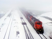 This is one of the things that I do not miss about Alberta - snow in May. We received 20 cm overnight. Had it occurred a day earlier, my wife and I would have been caught out of town on our bicycles. We had gone camping. The snow would have been a very unwelcome sight.
As it turned out, in town, I was able to negotiate the roads that morning and got out to Bissell. Not much was happening, but eventually the eastbound came in. Judging by the consist, it appeared to be #218 (or its equivalent in 1987.