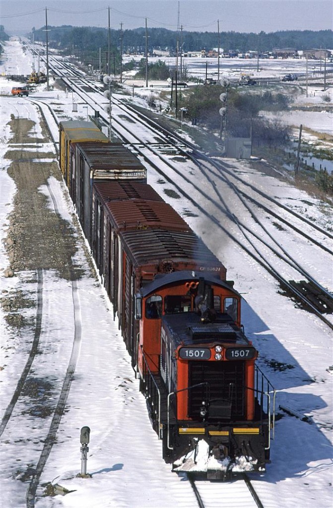 This is my other photograph taken on May 20, after a 20 cm snowfall. It is only 1000hrs but with the sun out now, the snow is melting fast.
This switcher has completed their task in Zone M (off to the left of the photo) and is heading back to Calder Yard.