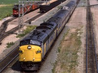 A 135mm lens view of the westbound "Super Continental" passing through Bissell yard. A lot has happened since the noon hour (This short was taken at 1452hrs). The track to the south cleared out and an empty welded rail train arrived. The Sulphur cars, however remain.
That is Inland Cement dominating the background.