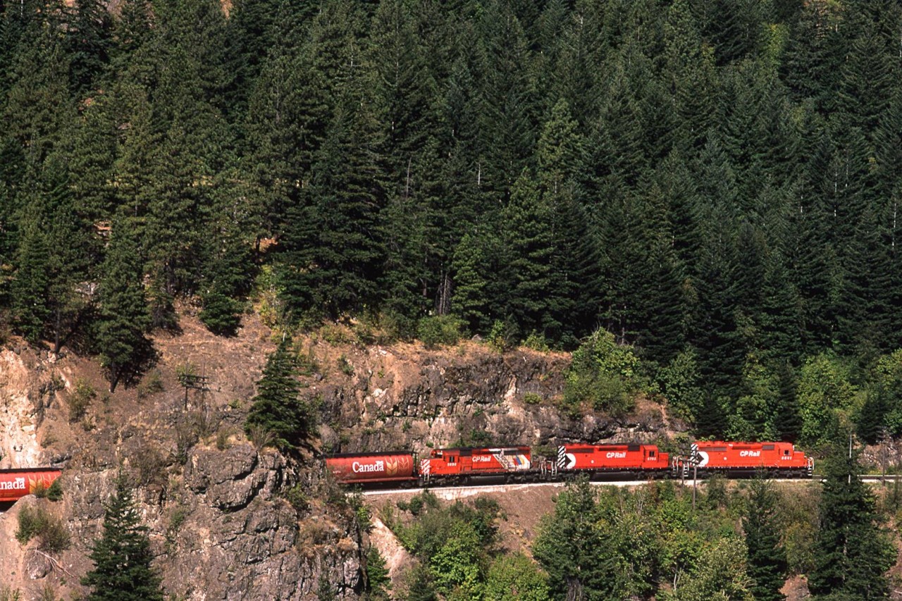 Looking like a model train layout in the basement of some railfan's home, this eastbound CP empty grain train is about to enter the tunnel just before emerging on their bridge over the Fraser River at Cisco. Directional running in the canyon was only a thought for those more progressive thinking RR operations leaders.