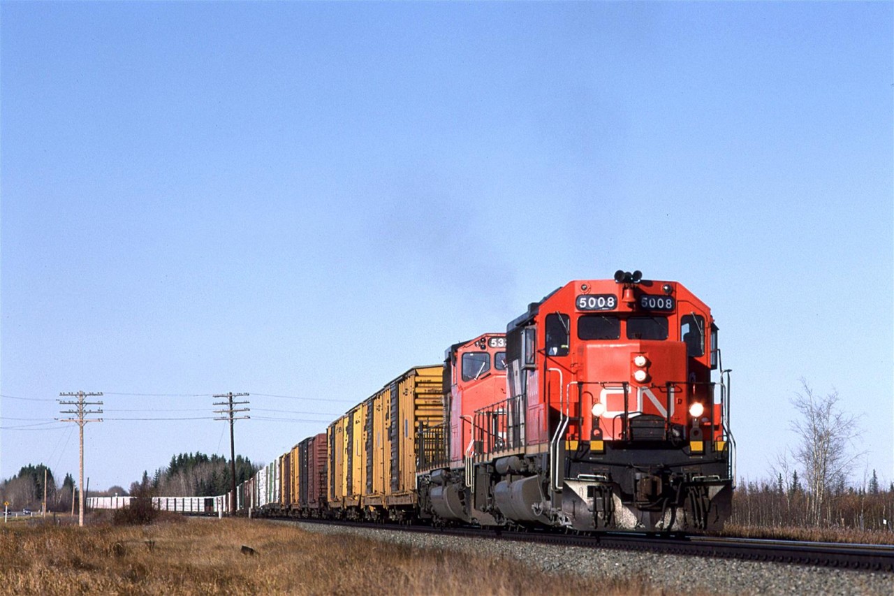 After taking my brother to Marias Pass and Kicking Horse pass the previous weekend, we ventured out to Jasper. Along the waym we caught this wood products train near Chip Lake (RR name Leaman). I was configured as it should be, with the conventional cab leading and the ugly wide nose trailing.
I would soon learn that there were two wood trains that came out of Prince George almost daily. Both would come into Edmonton, but 358 would take the Vegreville Sub and 360 would continue east on the Wainwright Sub.