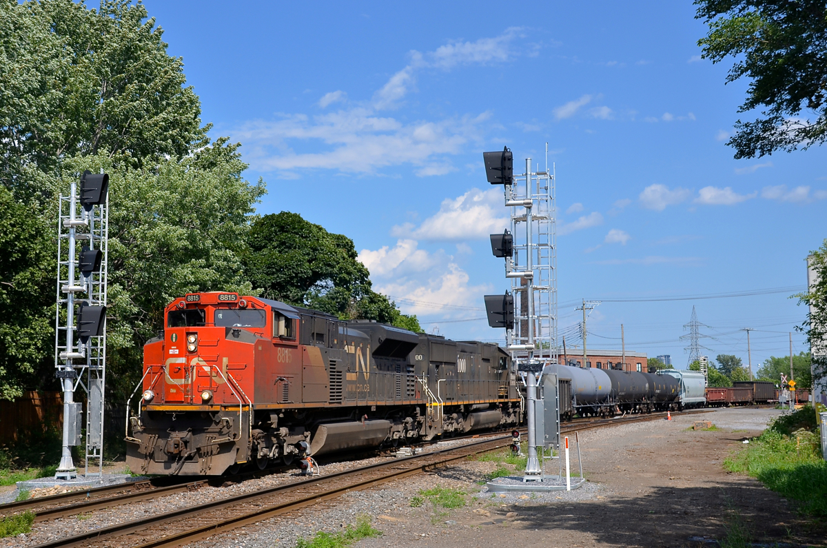 Past the old and new signals. CN X321 is passing a set of old dwarf signals that will soon be replaced by the new signals that are currently turned away from the track. Power on this train originating at Southwark yard on an as needed basis is CN 8815 and IC 1000.