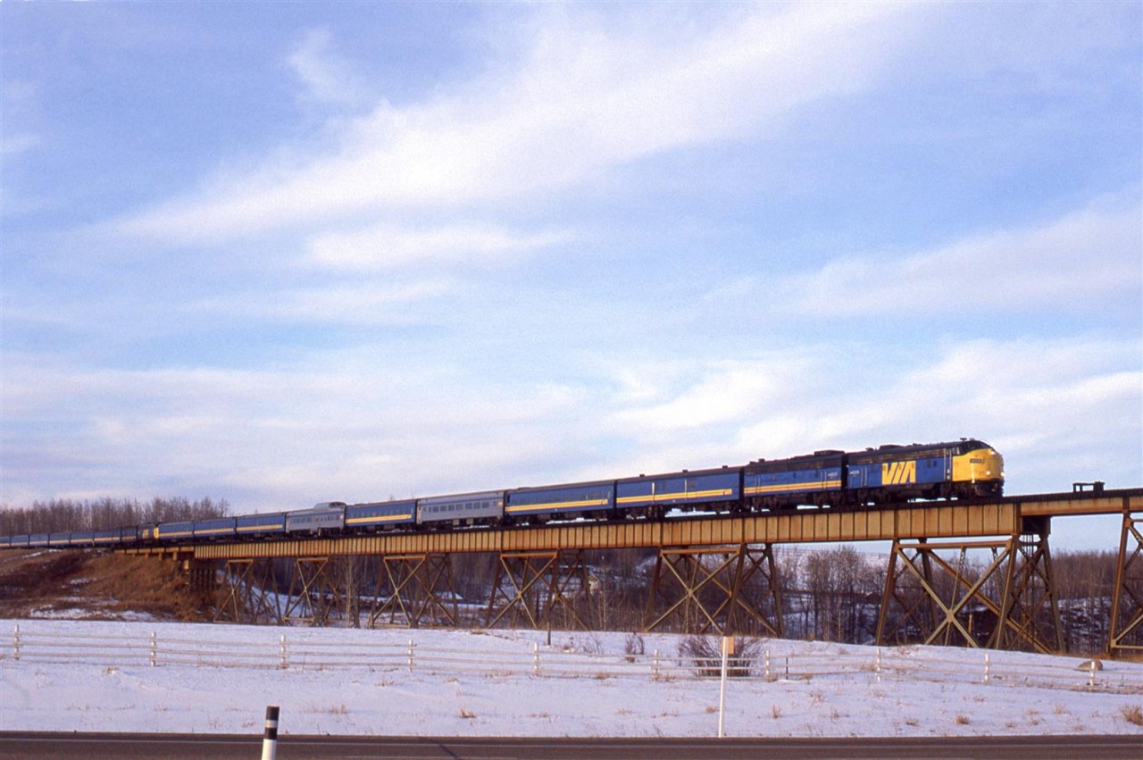 The combined "Super Continental" and "Skeena" are seen on the Magnolia bridge just west of Gainford. Highway 16 is seen in the foreground.