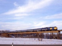 The combined "Super Continental" and "Skeena" are seen on the Magnolia bridge just west of Gainford. Highway 16 is seen in the foreground.
