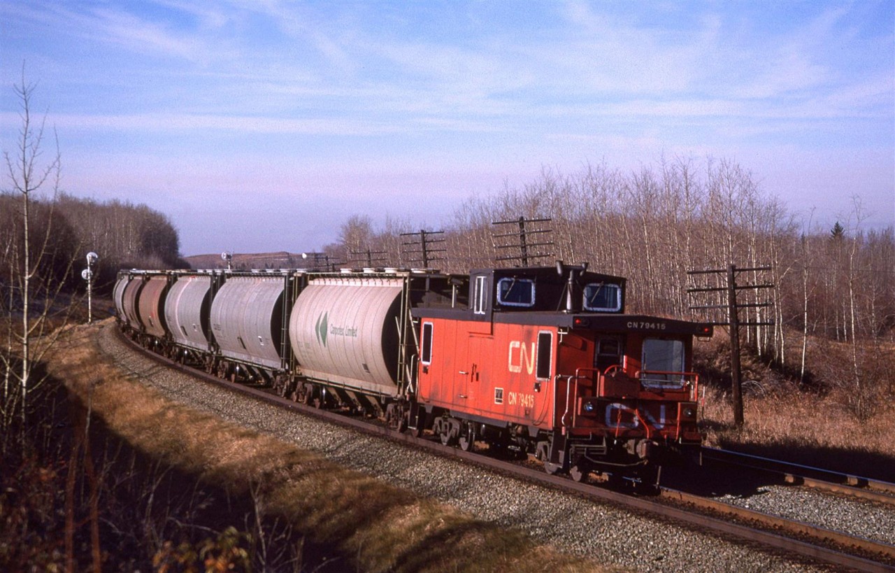 #759, a loaded potash train, rounds the curve that brings the Edson Sub back to a westerly direction.
According to the map that I had been using at the time, there used to be a bridge over the tracks for the township road where I am standing. By 1988, it had been removed and the road dead-ended at the tracks. Trevor S has a drone view looking the other way.
https://www.flickr.com/photos/66869919@N04/20588377359/in/dateposted/