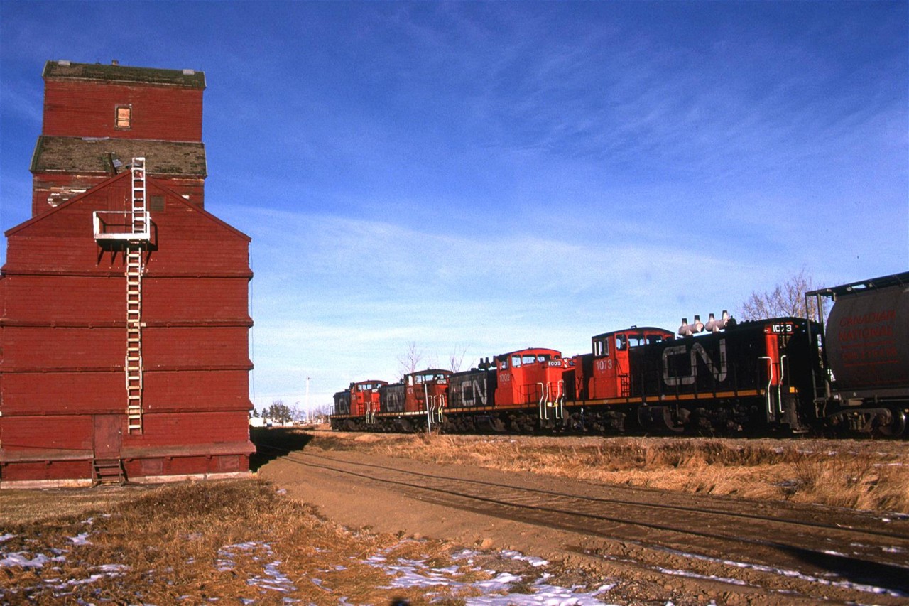 Another town, another grain elevator, another siding and another dropping of cars to be filled. This is all abandoned now, and the elevators have be razed.