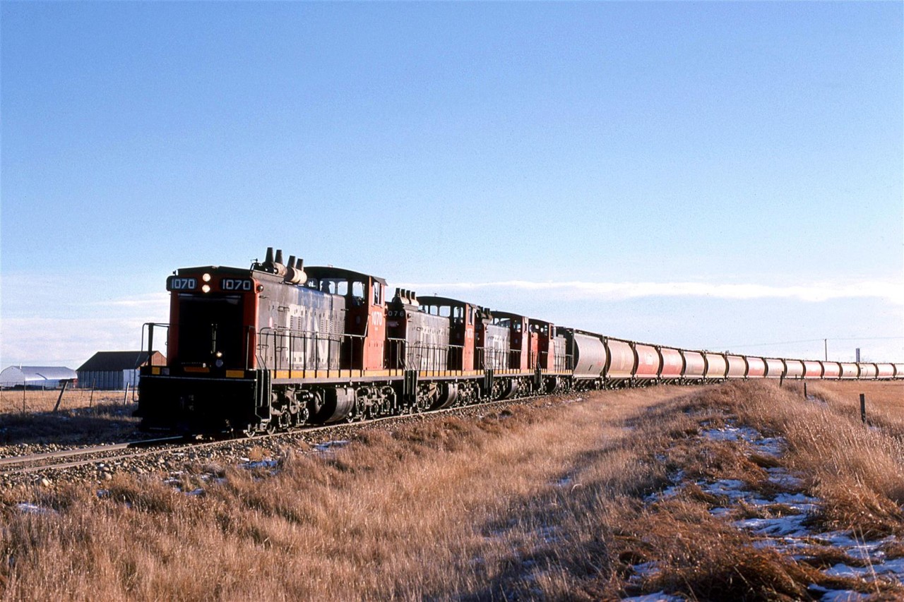 There are problems with chasing a northbound train, in particular, it is difficult to shoot into the sun. At Clyde the tracks made a sweeping curve to the left, which at least gave a slightly more pleasing view of the train. 
In December, in Alberta, however, there is the problem with little daylight altogether. We could not chase this train all the way to Athabasca, but we would get one more shot.