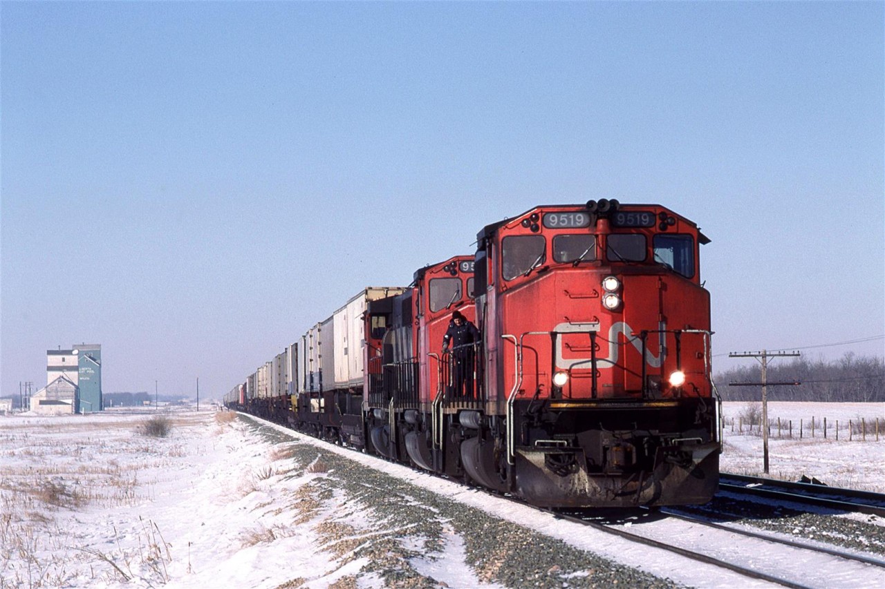 214 stops at Bruce to meet the eastbound "Super Continental". The engineer decided that it would be a good time to check something on the lead locomotive.
This meet could not happen to today, a this siding has been removed (as have several others on the Wainwright Sub.