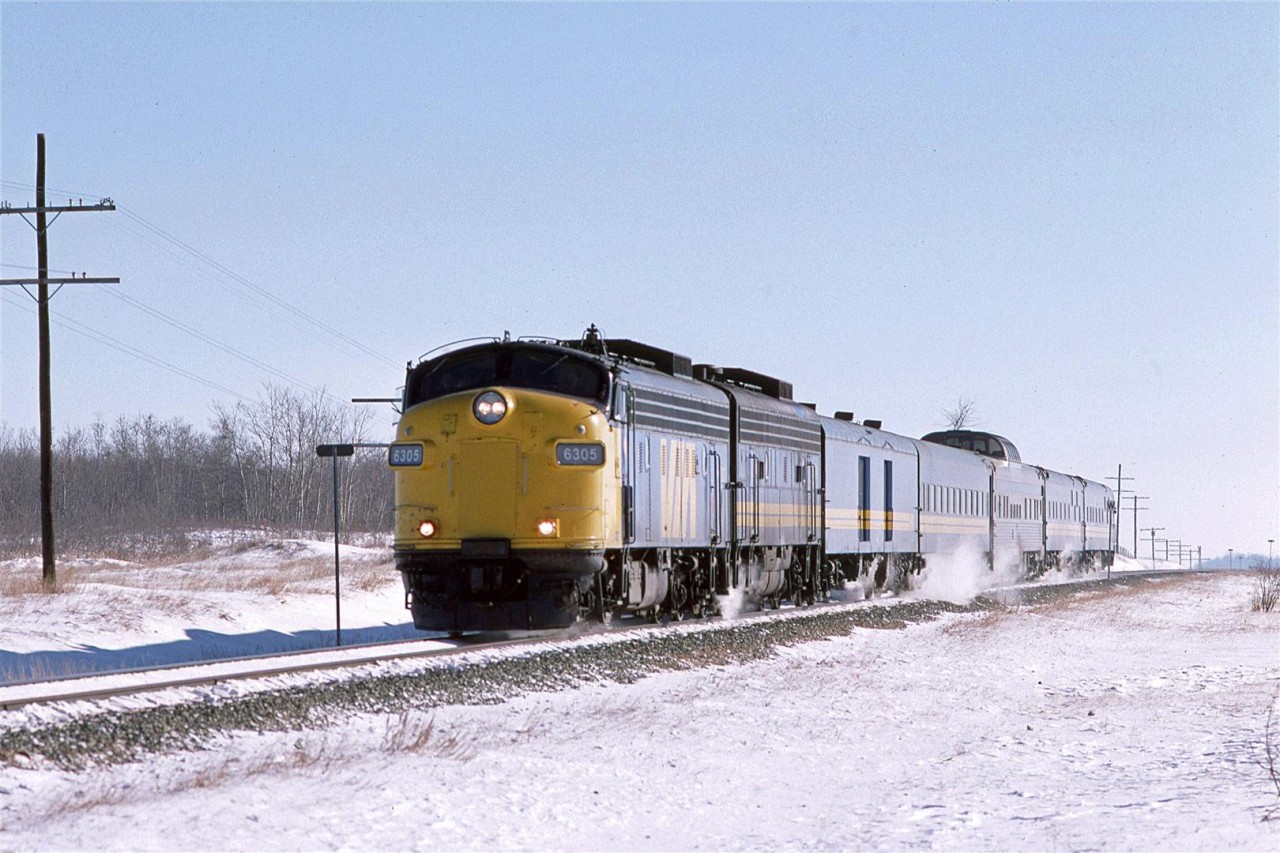 A short westbound "Super Continental"  zips through the rather dull landscape between Tofield and Viking, Alberta. The old covered wagons are living on borrowed time now as new F40PH's will soon force most of the older units into retirement.